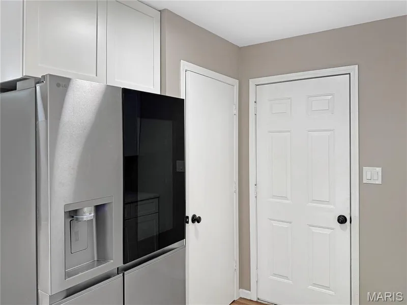 New refrigerator, doors to pantry and garage. — 6 Whispering Rock Court, O'Fallon, MO 63366