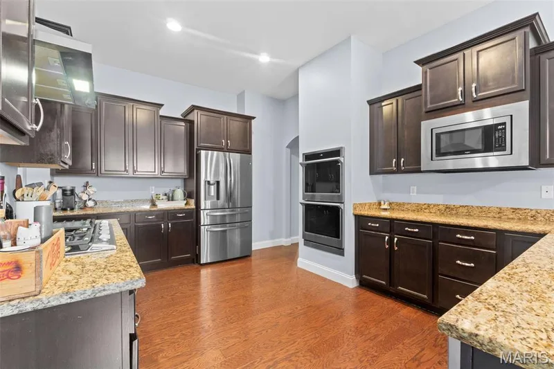 Upgraded chefs Kitchen w/ recessed lighting, granite counters, staggered cabinets,  Built in double ovens, stainless appliances, and so much more! — 14 Prairie Lake Court, Wentzville, MO 63385