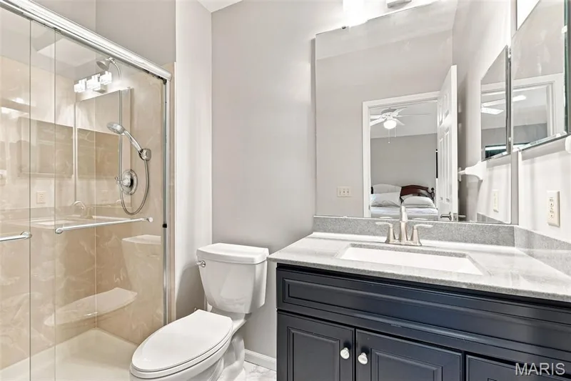 Glass-enclosed shower with a handheld showerhead and built-in bench — 16561 Carriage View Court, Wildwood, MO 63040