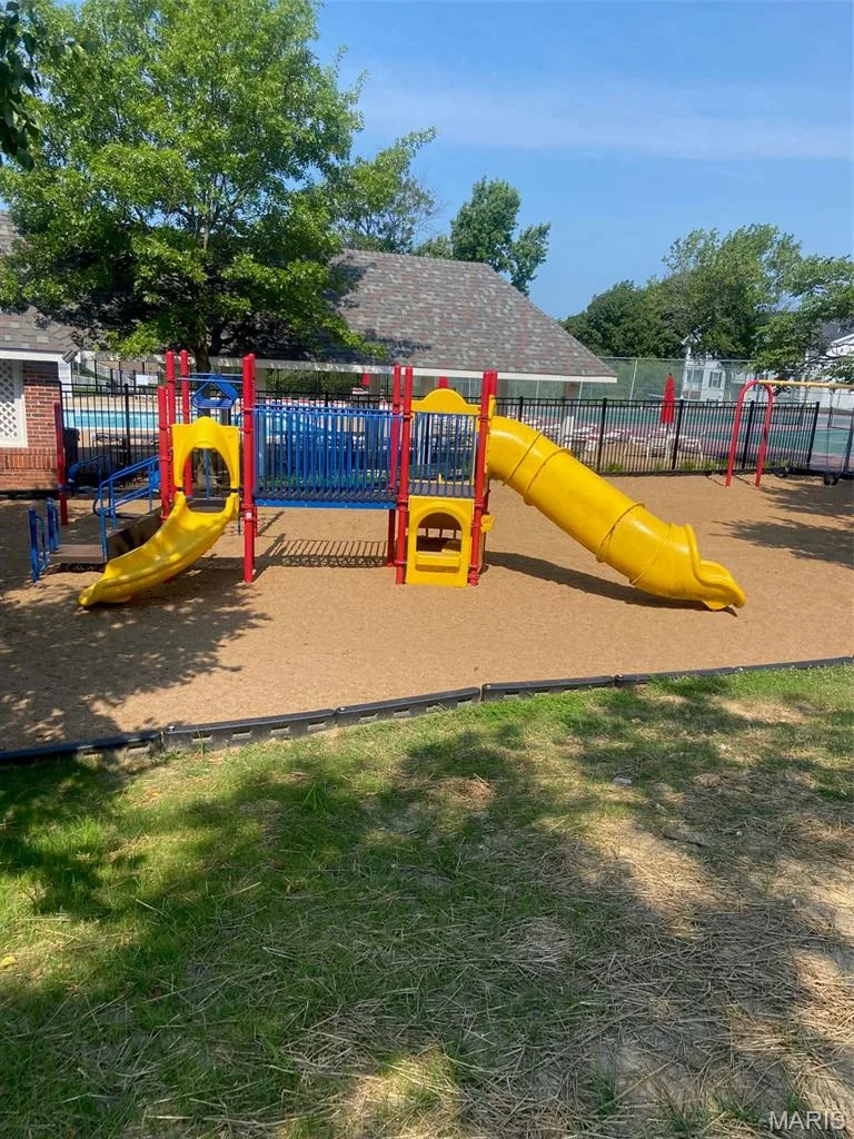Recreational playground area featuring a multi-component play structure with slides and climbing elements — 16561 Carriage View Court, Wildwood, MO 63040