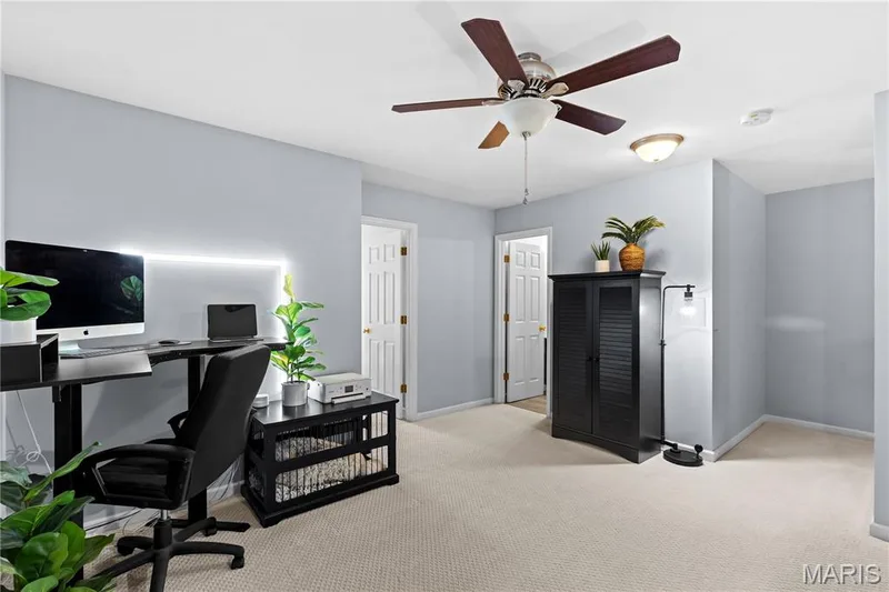 Neutral-toned wall-to-wall carpeting complements light gray wall paint — 349 Shady Rock Lane, O'Fallon, MO 63368