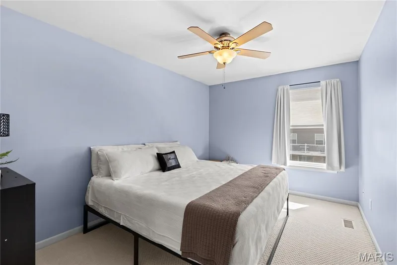 Bedroom featuring light blue walls and a neutral carpet — 349 Shady Rock Lane, O'Fallon, MO 63368