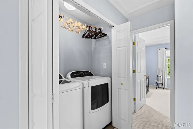 Dedicated laundry closet featuring a top-load washer and front-load dryer — 349 Shady Rock Lane, O'Fallon, MO 63368