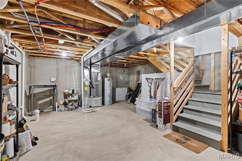 Unfinished basement with concrete flooring and exposed ceiling joists — 349 Shady Rock Lane, O'Fallon, MO 63368