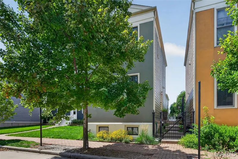 Contemporary townhouse exterior featuring a warm ochre facade and dark trim — 3471 Hiram Street, St Charles, MO 63301