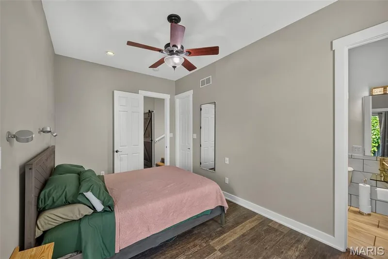 Spacious bedroom featuring neutral wall finishes, wood-finish flooring, and recessed ceiling lighting — 3471 Hiram Street, St Charles, MO 63301