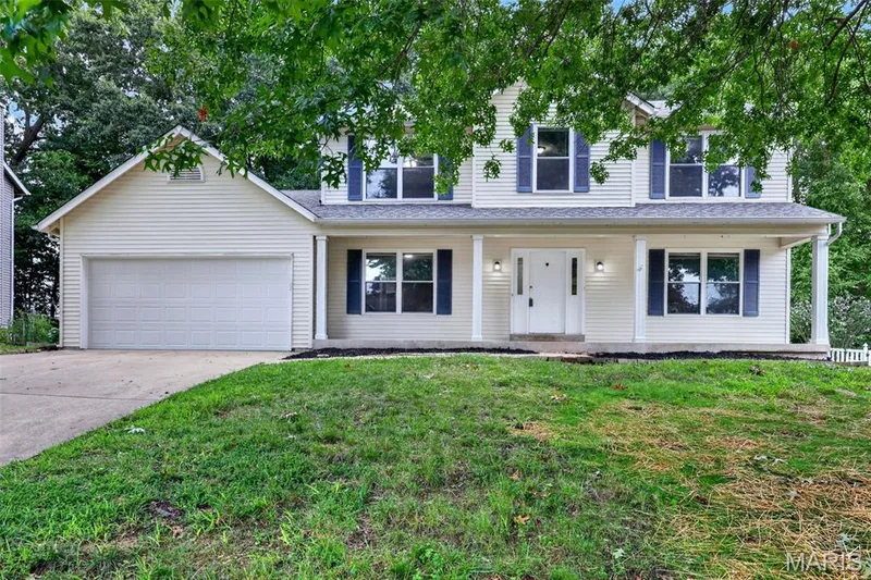 Two-story colonial with white vinyl siding and attached two-car garage — 2947 Bromley Drive, O'Fallon, MO 63368