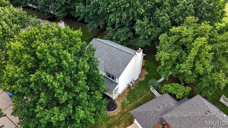 Two-story residence featuring a gray shingle roof and a white exterior with a chimney — 2947 Bromley Drive, O'Fallon, MO 63368