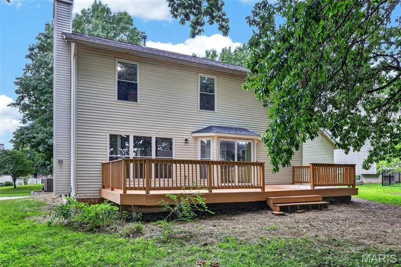 Spacious rear deck with wood railing — 2947 Bromley Drive, O'Fallon, MO 63368