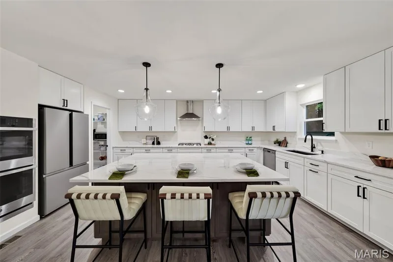 Cozy up to the massive center island breakfast bar in the heart of the home — 310 Osprey Court, Lake St. Louis, MO 63367