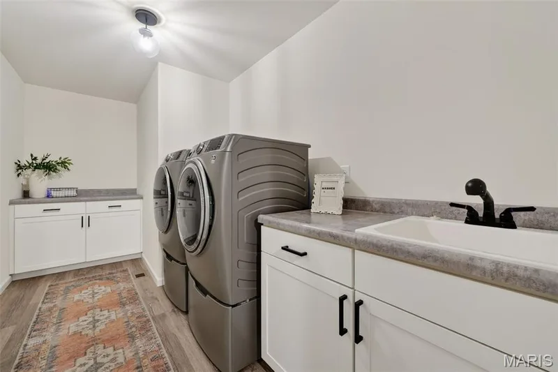 Main floor laundry room with utility sink, washer and dryer stay! — 310 Osprey Court, Lake St. Louis, MO 63367