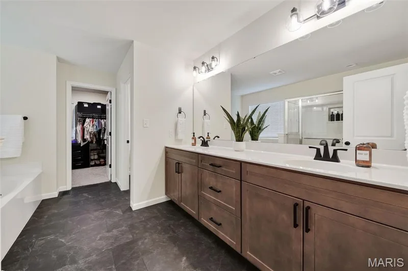Luxurious primary bathroom with dual sinks — 310 Osprey Court, Lake St. Louis, MO 63367