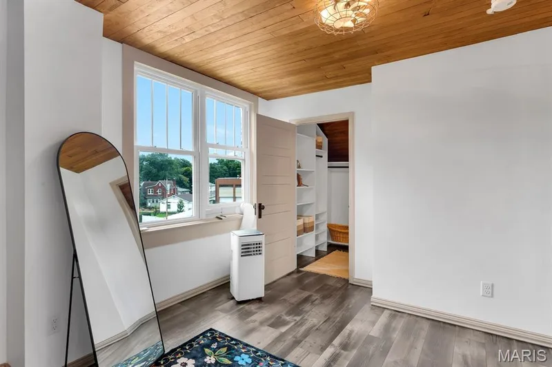 2nd bedroom on upper level staged as a dressing room.  Features a wood ceiling & walk-in closet with custom storage — 915 N Kingshighway Street, St Charles, MO 63301