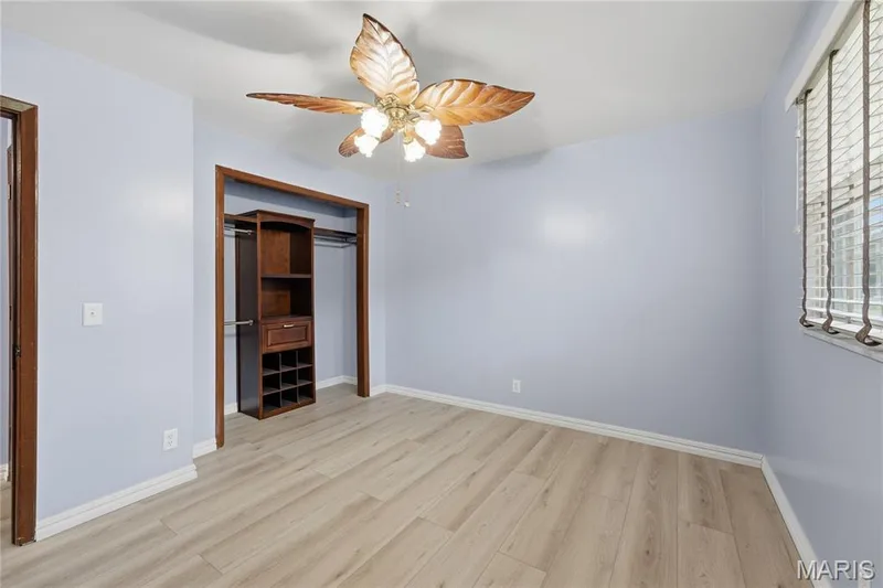 Room featuring wood-finish flooring, and white baseboards — 1613 Tamarack Drive, St Charles, MO 63301