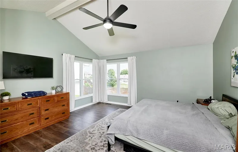 Vaulted ceiling with an exposed beam and a ceiling fan with integrated lighting — 3 Floral Court, O'Fallon, MO 63368