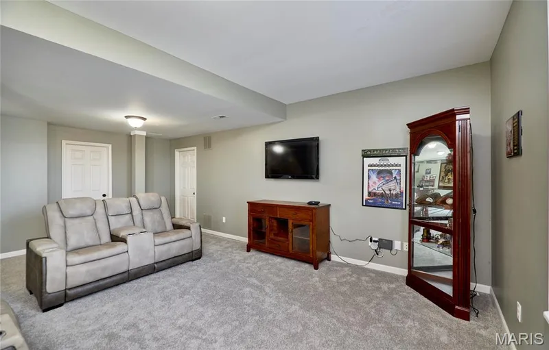 Spacious room featuring light gray walls, plush gray carpeting, and white trim — 3 Floral Court, O'Fallon, MO 63368