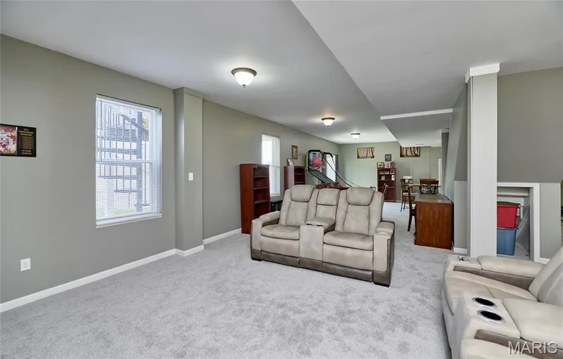Spacious room featuring light gray walls, light gray carpeting, and white trim — 3 Floral Court, O'Fallon, MO 63368