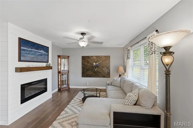 Living room features an electric fireplace and big windows. — 17 Oak Hill Lane, St Peters, MO 63376