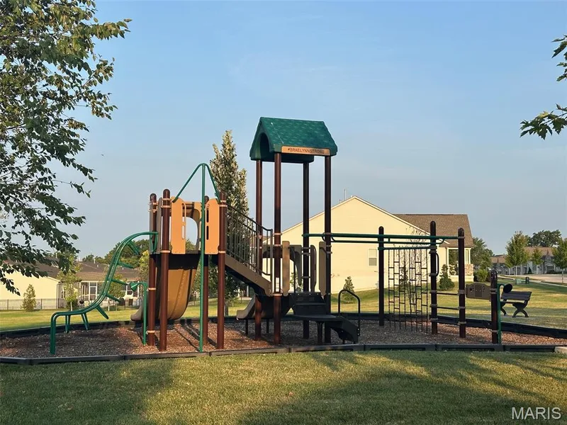 Outdoor playground structure featuring multiple slides, climbing elements, and a covered platform — 110 Alta Mira Court, Dardenne Prairie, MO 63368