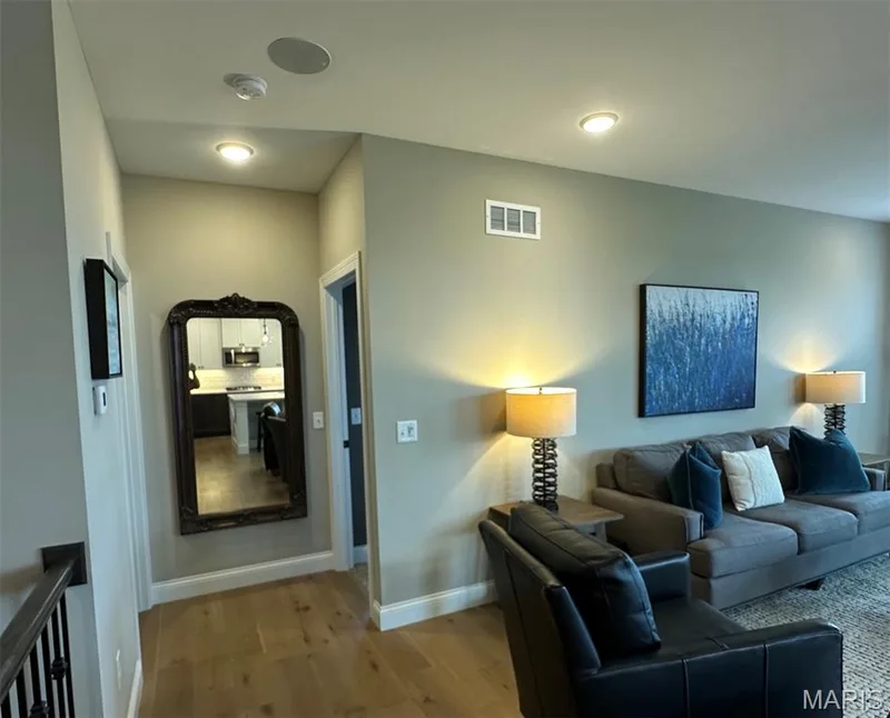 Hardwood-finish flooring extending through the hallway and living area — 110 Alta Mira Court, Dardenne Prairie, MO 63368