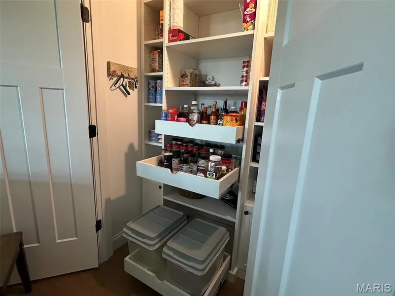 Built-in pantry system featuring adjustable shelving, multiple pull-out drawers, and integrated storage bins — 110 Alta Mira Court, Dardenne Prairie, MO 63368