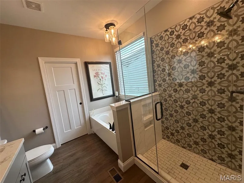 Walk-in shower with patterned wall tile and clear glass enclosure — 110 Alta Mira Court, Dardenne Prairie, MO 63368