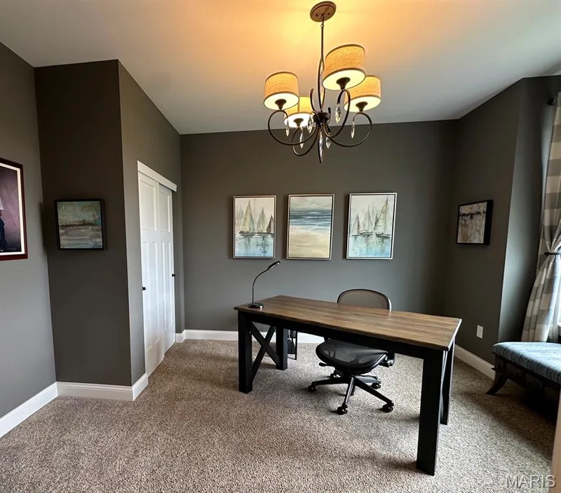 Room featuring a built-in closet with a white paneled door, carpet flooring, and a ceiling-mounted chandelier — 110 Alta Mira Court, Dardenne Prairie, MO 63368