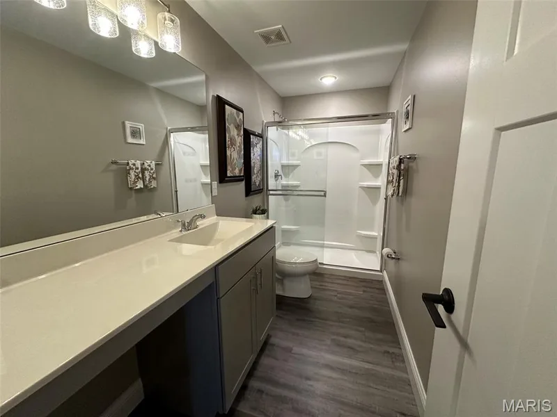 Bathroom featuring a spacious vanity with an integrated sink, extended countertop, and under-sink cabinetry — 110 Alta Mira Court, Dardenne Prairie, MO 63368