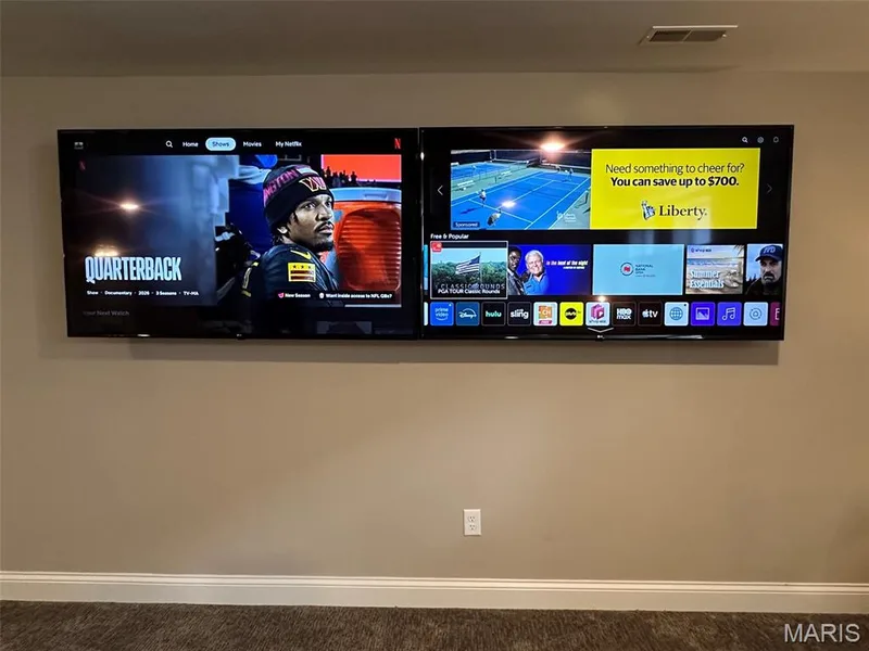 Dual wall-mounted televisions above a white baseboard — 110 Alta Mira Court, Dardenne Prairie, MO 63368