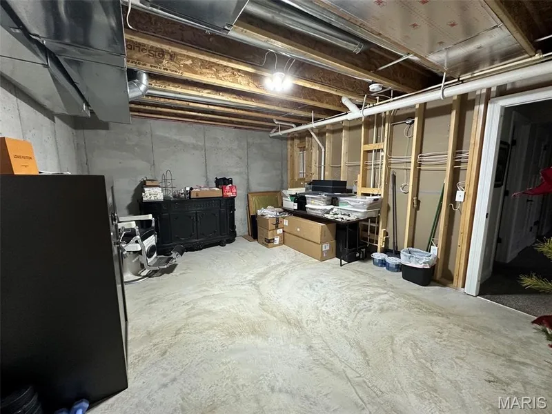 Unfinished basement with concrete slab flooring and exposed ceiling joists — 110 Alta Mira Court, Dardenne Prairie, MO 63368