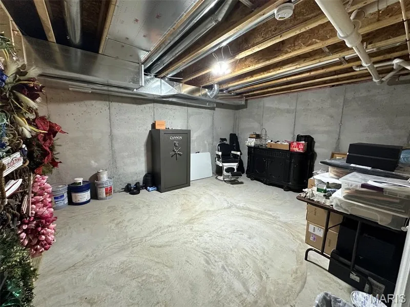 Unfinished basement with concrete slab flooring and exposed overhead joists — 110 Alta Mira Court, Dardenne Prairie, MO 63368