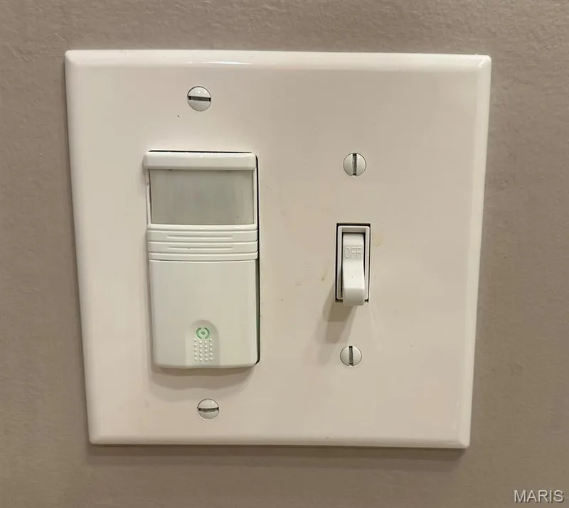 White light switch plate featuring a toggle switch and a motion sensor — 110 Alta Mira Court, Dardenne Prairie, MO 63368