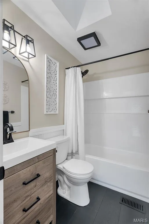 Wood-finish vanity with white countertop, black hardware, and coordinating faucet — 104 Cedar Crest Court, St Charles, MO 63304