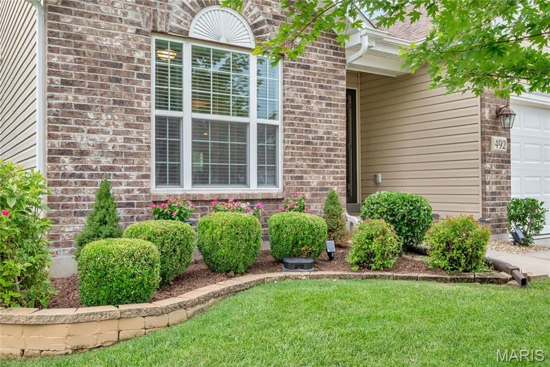 Close-up view of the well-manicured/landscaped front — 492 Pleasant Breeze Drive, Wentzville, MO 63385