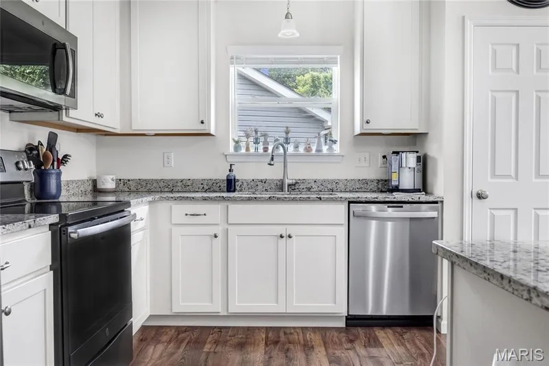 Another view of the granite countertops, stainless steel dishwasher, smooth-top range & microwave — 492 Pleasant Breeze Drive, Wentzville, MO 63385