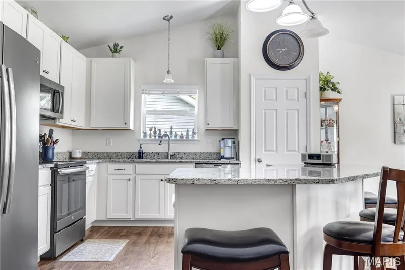 Updated kitchen with oversized breakfast bar overhang — 492 Pleasant Breeze Drive, Wentzville, MO 63385