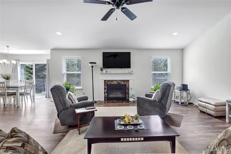 Vaulted great room with gas fireplace and ceiling fan, overhead can lights, luxury vinyl plank flooring — 492 Pleasant Breeze Drive, Wentzville, MO 63385