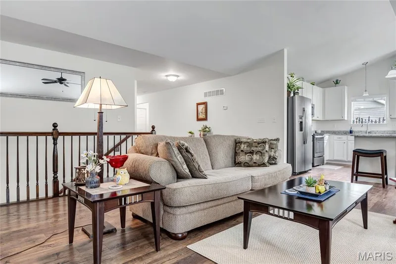 Another view of the great room + open spindled stairway — 492 Pleasant Breeze Drive, Wentzville, MO 63385