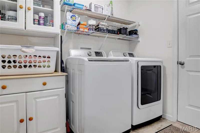Main floor laundry room between garage and entry foyer — 492 Pleasant Breeze Drive, Wentzville, MO 63385