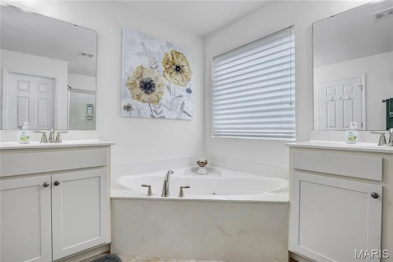 Another view of the jetted soaker tub and adult height vanities — 492 Pleasant Breeze Drive, Wentzville, MO 63385