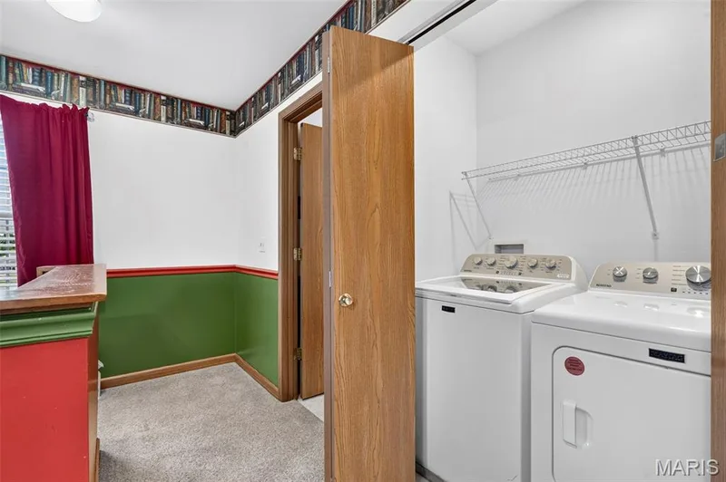 Laundry area with wire shelving and two doors — 669 Homerun Drive, O'Fallon, MO 63366