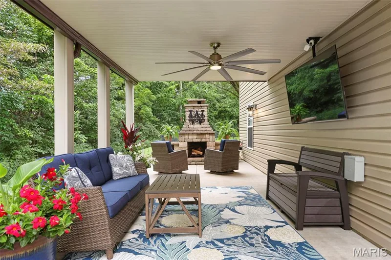 The deck is enclosed to provide a ceiling for your outdoor entertaining. There is electric in place for a hot tub if you choose to add. — 132 Miranda Court, Wentzville, MO 63385