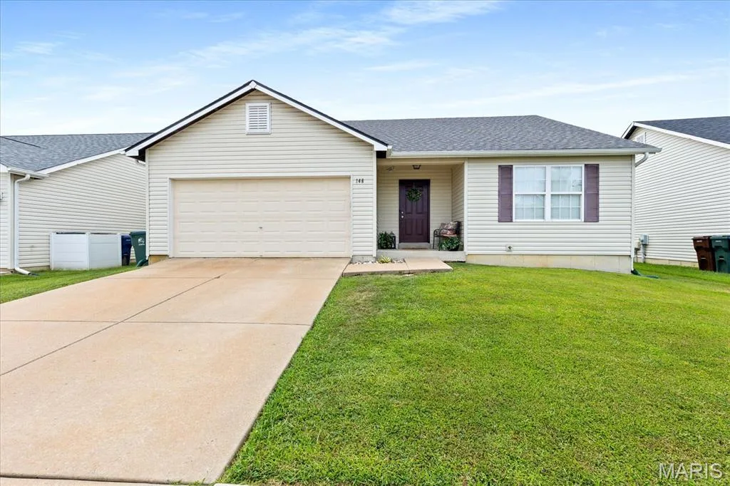Welcome to Wentzville! Step right into this charming three bedroom, two bathroom ranch featuring a cozy covered porch, 2-car garage, and inviting curb appeal. — 146 Tuscany Lane, Wentzville, MO 63385
