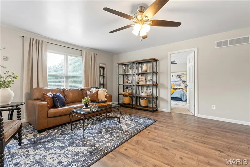 Spacious living room showing seamless flow to the main suite and easy connectivity to the rest of the home. — 146 Tuscany Lane, Wentzville, MO 63385