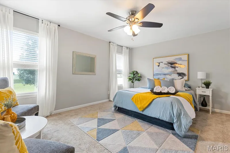 Retreat at the end of the day to a spacious primary suite filled with soft daylight from the dual windows. — 146 Tuscany Lane, Wentzville, MO 63385