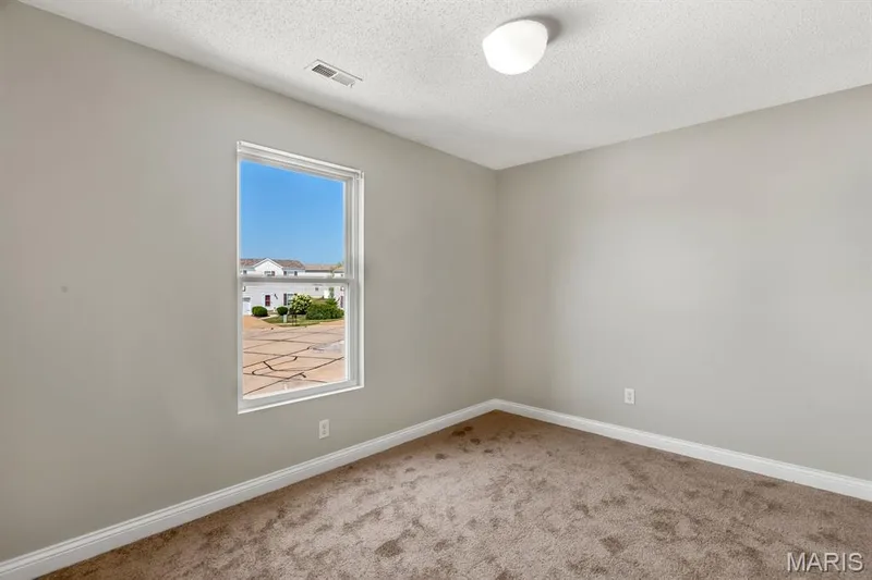 Neutral wall color with textured ceiling, a single window, and carpeted flooring — 14 Bridgeton Court, Wentzville, MO 63385