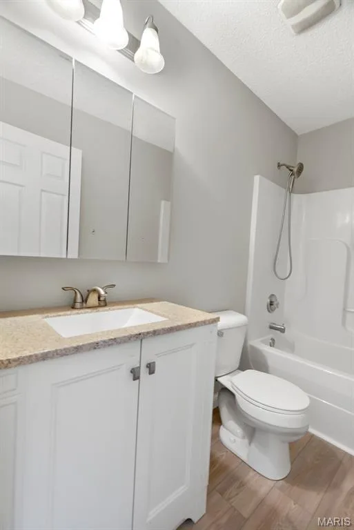 White vanity with a neutral-toned countertop and an undermount sink — 14 Bridgeton Court, Wentzville, MO 63385