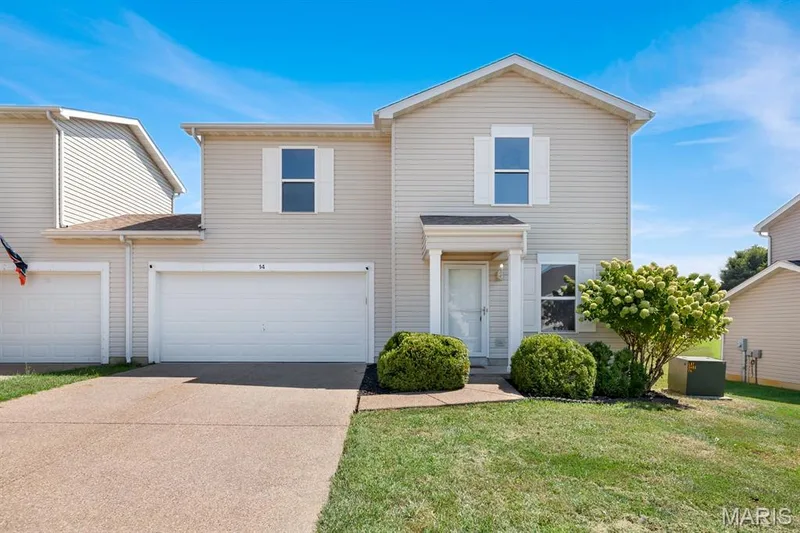 Two-story residence featuring light-colored siding, a covered entryway, and white window shutters — 14 Bridgeton Court, Wentzville, MO 63385