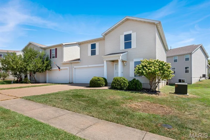 Light-toned siding exterior with white window shutters — 14 Bridgeton Court, Wentzville, MO 63385