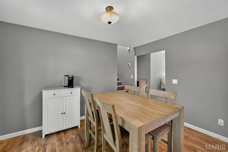 Dining room featuring  laminate wood-finish flooring — 23 Crescent Woods Drive, St Peters, MO 63376